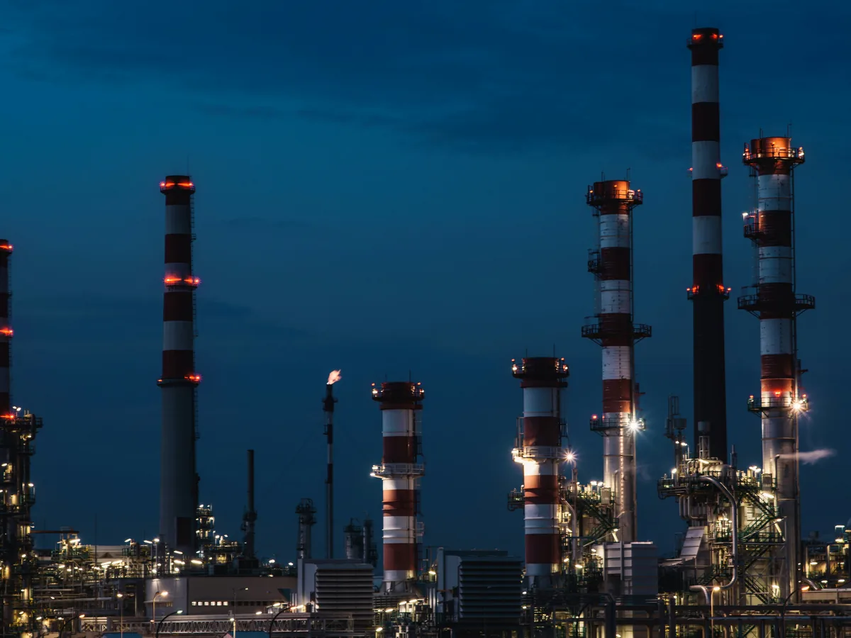 Oil refinery process columns and stacks illuminated at night