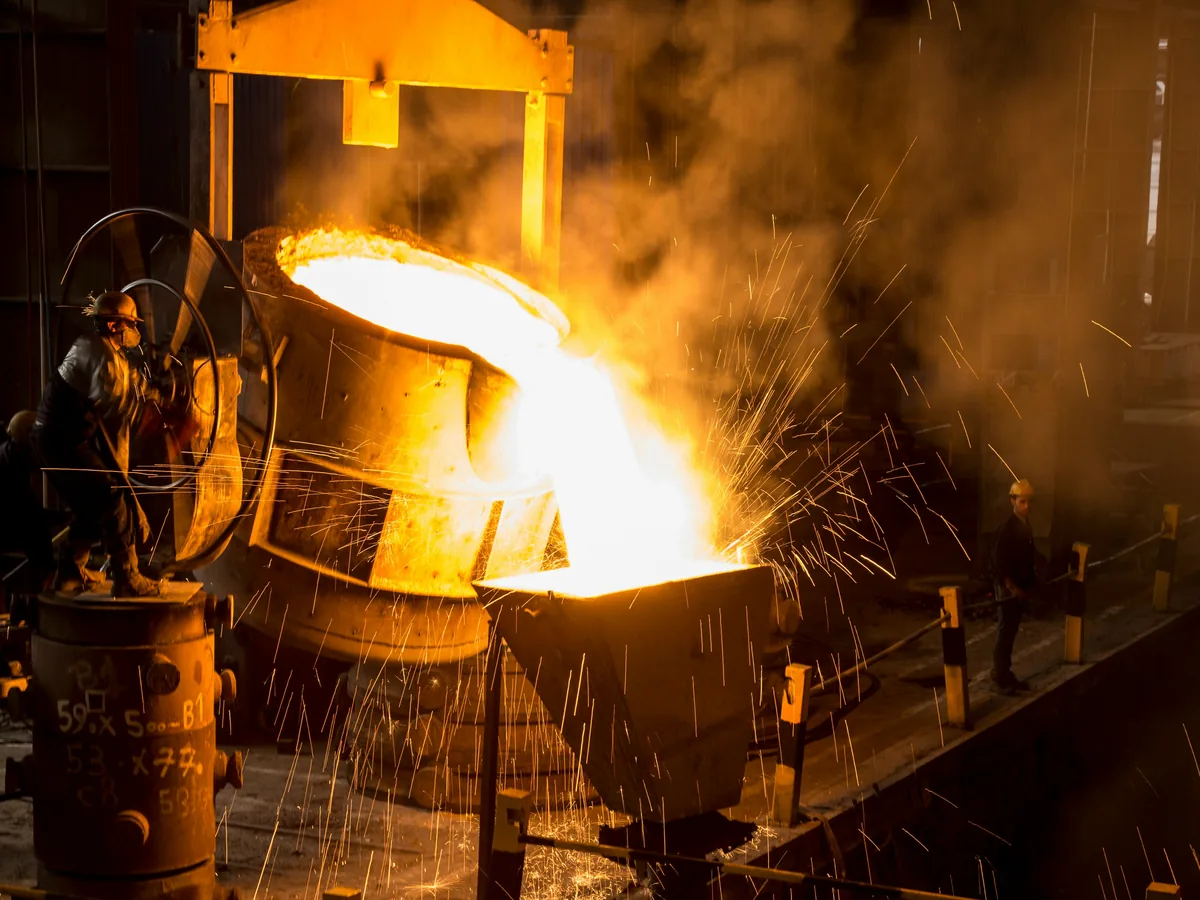 Molten metal being poured from a ladle in a steel mill