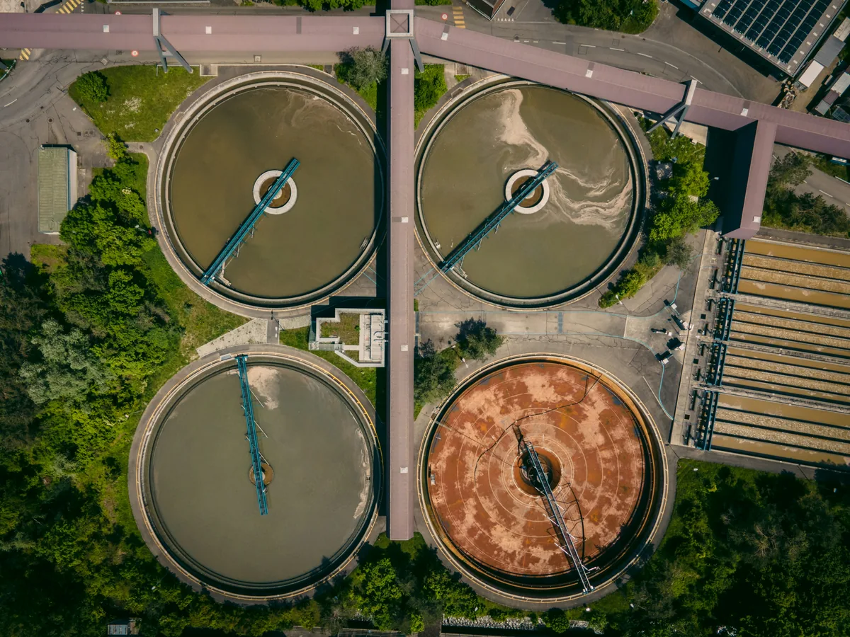 Aerial view of circular clarifier tanks at a wastewater treatment plant